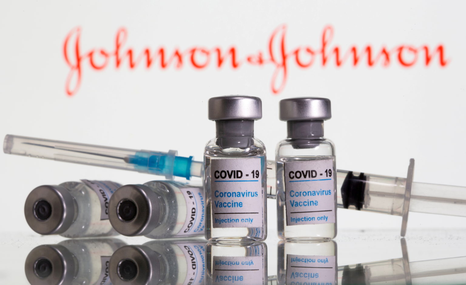 FILE PHOTO: Vials labeled “COVID-19 Coronavirus Vaccine” and syringe are seen in front of displayed Johnson&Johnson logo in this illustration taken, February 9, 2021. REUTERS/Dado Ruvic/Illustration